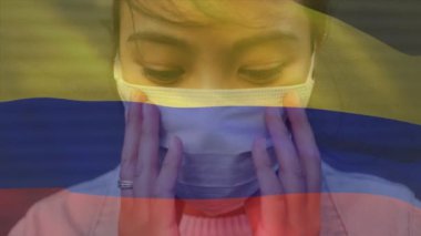Yüzünde maske olan Asyalı bir kadının portresine karşı Kolombiya bayrağı sallama animasyonu. Küresel covid-19 salgın konsepti