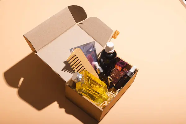 Box with beauty products and copy space over cream background. Cyber monday, black friday, online shopping, shipping and global connections concept.