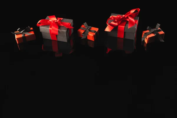 Schwarz Rote Geschenkboxen Mit Schleife Und Kopierraum Auf Schwarzem Hintergrund — Stockfoto
