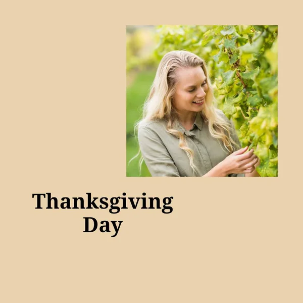 Thanksgiving day text on beige and smiling caucasian woman in garden. Thanksgiving, harvest festival, american tradition and autumn celebration digitally generated image.