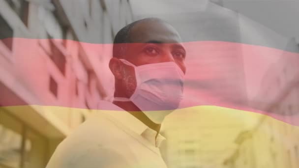Animace Mávání Německou Vlajkou Proti Africkému Američanovi Maskou Obličeji Ulici — Stock video
