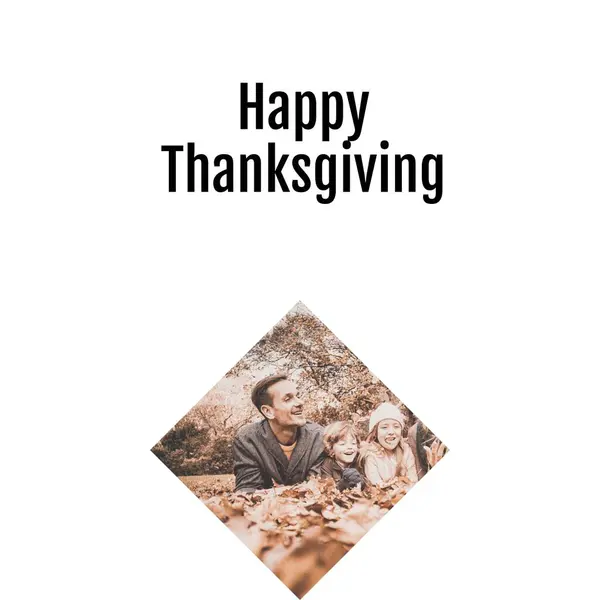 Happy thanksgiving text and happy caucasian father and children lying in autumn leaves. Thanksgiving, harvest festival, american tradition, family and autumn celebration digitally generated image.