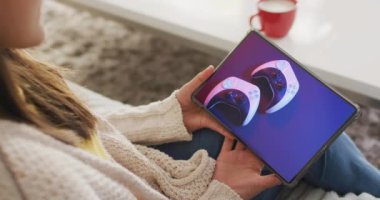 Beyaz bir kadın online alışveriş için tablet kullanıyor. Oyun kumandası Screnn 'de, ağır çekimde. Çevrimiçi alışveriş, perakende ticaret, satış, iletişim ve dijital video arayüzü.