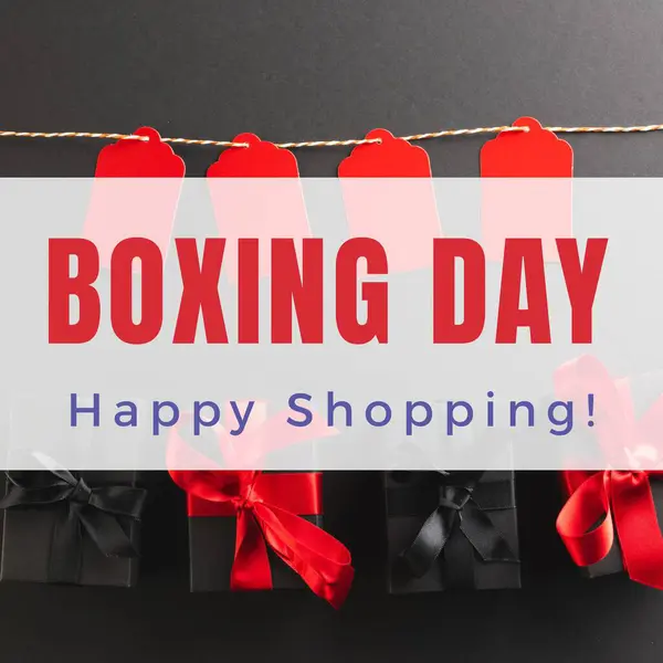 Composite of boxing day, happy shopping text over gift boxes and red tags on black background. Shopping, sale, surprise, discount, marketing, template, design, retail, advertise concept.