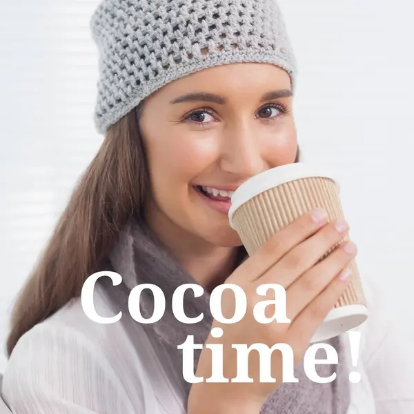 Composite of cocoa time text over happy caucasian woman drinking takeaway coffee in winter scenery. Winter, christmas, seasons and celebration concept digitally generated image.