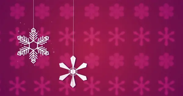 Composite with white snowflakes over snowflake pattern on pink background. Christmas, tradition and celebration concept digitally generated image.