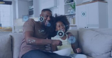 Evde televizyon izleyen Afrikalı Amerikalı baba ve oğluna karşı veri işleme animasyonu. Babalık, aşk ve teknoloji kavramı