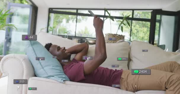 Animación Barras Notificación Sobre Hombre Afroamericano Acostado Sofá Desplazándose Teléfono — Vídeo de stock