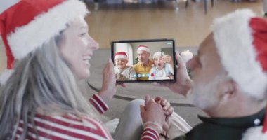 Kafkasyalı büyükanne ve büyükbaba, baba ve oğulların noel tabletinden aranıyorlar, ağır çekimde. İletişim, aile, arkadaşlar, Noel, kutlama, birliktelik, gelenek ve yaşam tarzı, değiştirilmemiş.