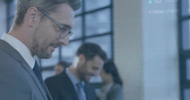 Animation of financial data processing over diverse business people in office. Global business, finances, computing and data processing concept digitally generated video.