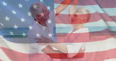 Yazın plajda Amerika bayrağının Kafkasyalı yaşlı çift üzerinde canlandırılması. Usa, Amerikan vatanseverliği, ulusal bayrak ve yaşam tarzı konsepti dijital olarak oluşturulmuş video.