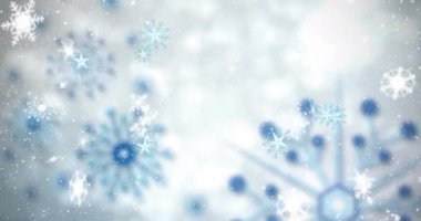 Fotokopi alanı olan gri arkaplana düşen kar tanelerinin animasyonu. Noel şenliği ve kutlama konsepti
