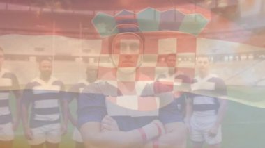 Hırvat bayrağının animasyonu rugby sahasında bir arada duran çeşitli erkek rugby oyuncularından oluşan takımın üzerinde. Spor, spor ve vatanseverlik kavramı