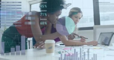 Animation of financial data processing over diverse businesswomen in office. Global business, finance, computing and data processing concept digitally generated video.