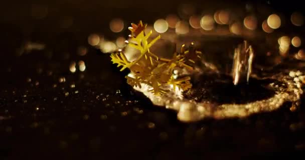 Animation Golden Snowflake Rotating Liquid Falling Ground Digital Composite Decoration — Stock Video