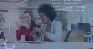 Animation of financial data processing over diverse businesswomen in office. Global business, finance, computing and data processing concept digitally generated video.