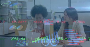Animation of financial data processing over diverse businesswomen in office. Global business, finance, computing and data processing concept digitally generated video.
