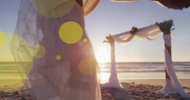 Afrika kökenli Amerikalı çiftin kumsalda evlenmesi üzerine ışıklı noktaların canlandırılması. Düğün günü, kutlama, birliktelik ve aşk konsepti dijital olarak oluşturulmuş video..