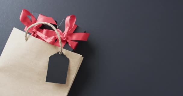 Brown Paper Gift Bag Vibrant Red Ribbon Blank Tag Lies — Stock Video