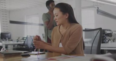 Ofiste çalışan çift ırklı iş kadınının veri işleme animasyonu. İş, iletişim, teknoloji, bilgisayar ve dijital arayüz kavramı dijital olarak oluşturulmuş video.