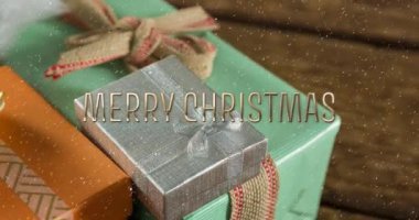 Noel hediyeleriyle yağan karla ilgili mutlu noel mesajlarının animasyonu. Noel, şenlik, kutlama ve gelenek konsepti dijital olarak oluşturuldu.