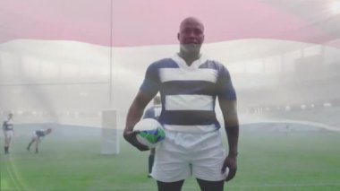 Stadyumda oynayan çeşitli erkek rugby oyuncuları üzerinde Avustralya bayrağı animasyonu. Küresel spor ve vatanseverlik kavramı, dijital olarak üretilen video.