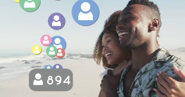Profile icons with increasing numbers floating against african american couple smiling on the beach. social media networking and vacation concept