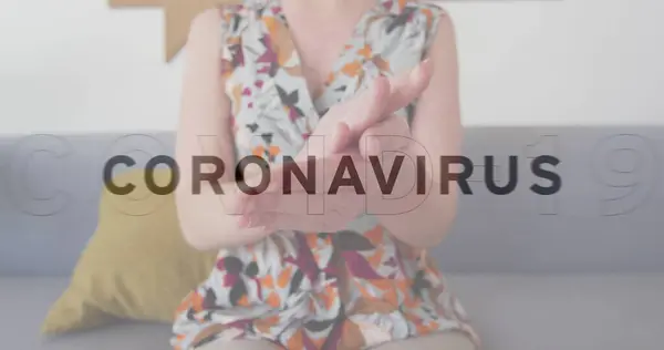 Image of multiple words flashing with woman disinfecting hands in office. healthcare and protection during coronavirus covid 19 pandemic, digitally generated image