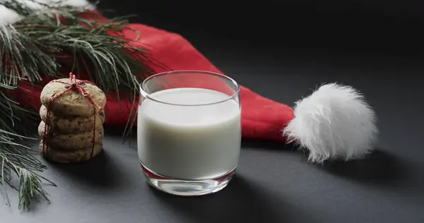 A glass of milk and cookies set out for Santa Claus, with copy space. Holiday traditions come to life in this home setting, evoking the spirit of Christmas.