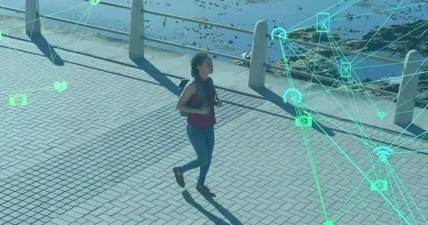 Image of network of connections with technological icons over woman walking on park. Digital interface global sport and performance concept digitallygenerated image.