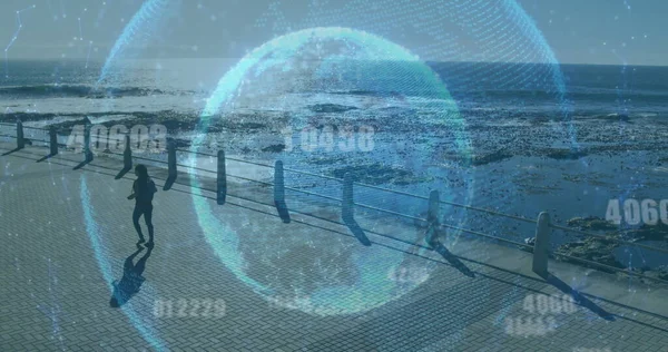 Image of globe with network of connections over woman walking, exercising by seaside. Digital interface global sport and performance concept digitally generated image.