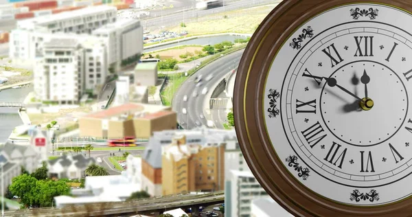 Image of clock ticking over cityscape. Global finance, business, connections, computing and data processing concept digitally generated image.
