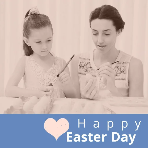Composition of happy easter day text over caucasian mother and daughter colouring eggs. Easter tradition and celebration concept digitally generated image.