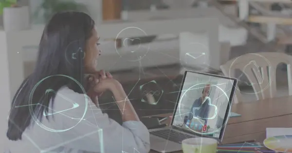 Image of digital icons over woman using laptop on image call in background. Digital interface global connection and communication concept digitally generated image.