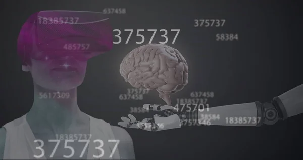 Image of numbers changing, human brain over robot\'s arm and woman wearing vr headset. Digital interface global connection and communication concept digitally generated image.
