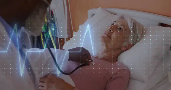 Image of heart data over african american male doctor with female patient. Global medicine, healthcare, digital interface, computing and data processing concept digitally generated image.
