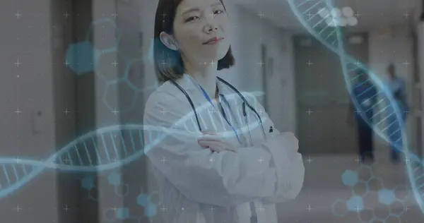 Image of dna strands over asian female doctor. Global medicine, healthcare, digital interface, computing and data processing concept digitally generated image.