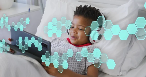 Image of medical data processing over biracial boy patient in bed. Global medicine, healthcare, digital interface, computing and data processing concept digitally generated image.
