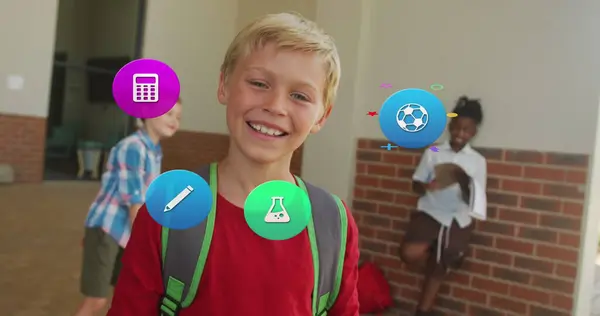 Image of school icons over smiling caucasian schoolboy with schoolbag in school corridor. School, education, childhood and learning, digitally generated image.