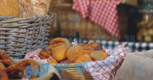 Image of statistics and data processing over bread in baskets in food shop. Business, retail, communication, digital interface, finance and data processing concept digitally generated image.