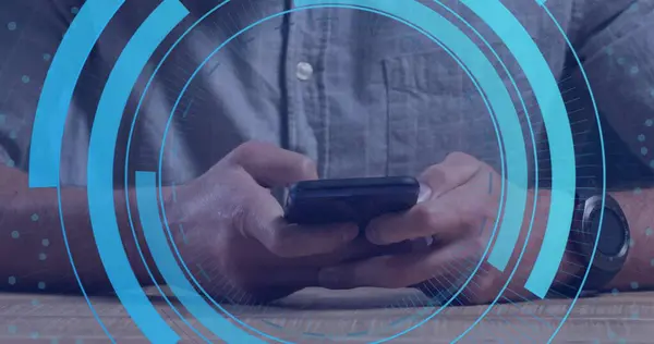 Image of processing circles over hands of caucasian man using smartphone. Network, data security and digital safety concept digitally generated image.