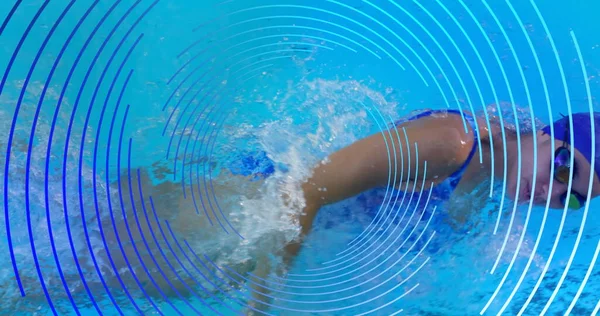 Image of blue line spiral rotating over woman swimming in pool. sport and fitness concept, digitally generated image.
