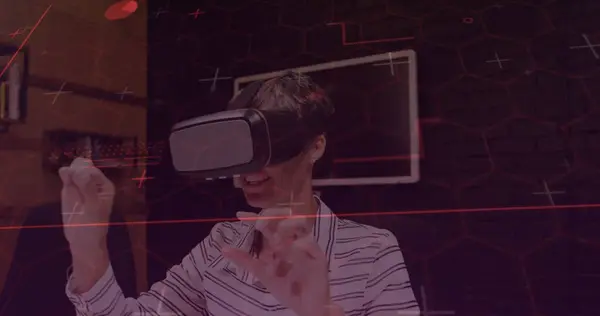 Image of purple light trails with hexagons over woman wearing vr headset and moving her hands. global technology, connections and digital interface concept digitally generated image.