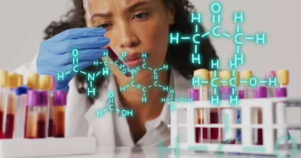 Image of chemical structures over biracial female doctor with test tubes. Global medicine and digital interface concept digitally generated image.