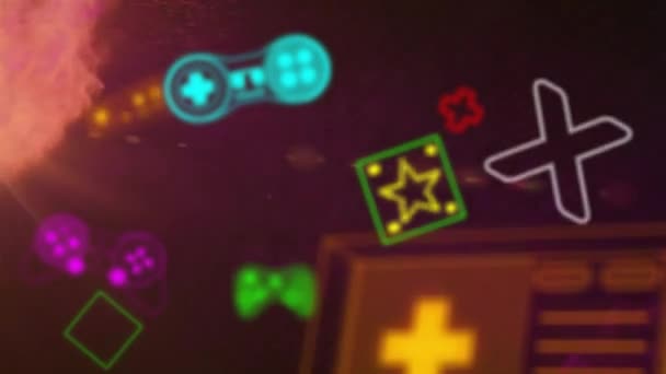 Renkli Video Oyun Kontrolörlerinin Sarı Turuncu Toz Parçacıkları Üzerindeki Ikonların — Stok video