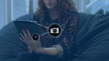 Tabletli beyaz kadın üzerindeki kamera simgeleriyle bağlantı ağının animasyonu. Küresel iş, bağlantılar, hesaplama ve veri işleme kavramı dijital olarak oluşturulmuş video.