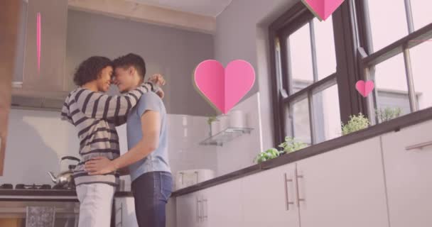 Animation Pink Hearts Happy Diverse Gay Male Couple Embracing Kitchen — Stock Video