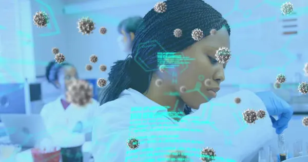 Image of coronavirus cells and data flowing over a female laboratory workers group examining samples. Covid 19 pandemic health care science medicine concept digital composite.