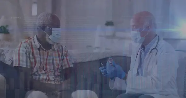 Image of data processing over caucasian male doctor with face mask talking with patient. global medicine and data processing during covid 19 pandemic concept digitally generated image.