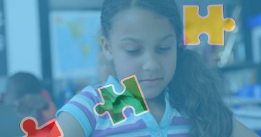 Tablet kullanan melez bir kız öğrencinin üzerindeki yapboz parçaları. otizm farkındalık ayı ve dijital olarak üretilen görüntü konsepti.